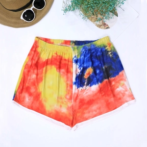Summer tie-dye beach shorts with elastic waist and white trim in a flat lay view