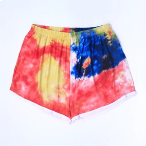 Detailed view of women tie-dye beach shorts with elastic waist and white contrast piping