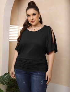Detail of plus size black cold-shoulder top featuring ruched sides and soft knit fabric
