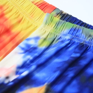 Close-up of elastic waistband detail on tie-dye beach shorts with fine stitching