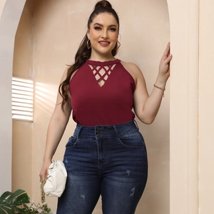 Close-up of burgundy halter top with diamond cutout neckline and high-waisted blue jeans