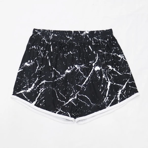 Flat lay of black and white marble print athletic shorts with white piping detail