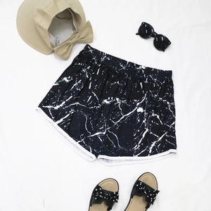 Women's beach shorts with black marble print, elastic waist and white contrast binding