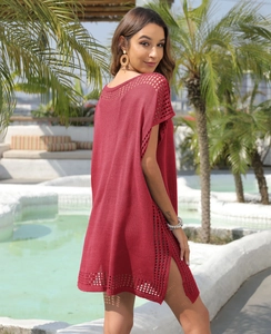 Macro detail of wine red hollow-out knit texture on a loose V-neck beach cover-up dress