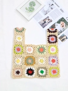 Detailed macro view of colorful handmade granny square crochet flower patterns on tote bag