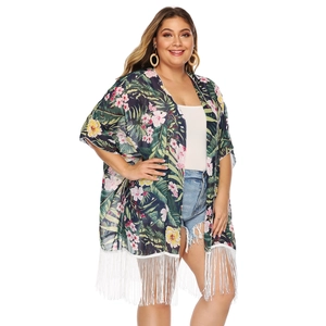 Detail of tropical floral print chiffon cardigan featuring white tassel fringe hem