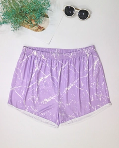 Detail of purple marble print beach shorts with white piping and elastic waistband
