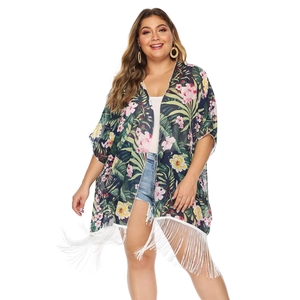 Detail of floral chiffon cardigan featuring tropical prints and white tassel hemline fringes