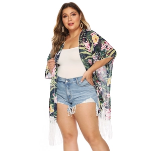 Detail of tropical floral print cardigan featuring white fringe tassels on the hem