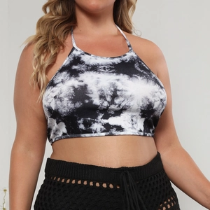 Detail view of black and white tie-dye halter neck crop top with thin straps for women