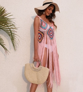 Detailed crochet patterns on pink tassel beach cover-up with bohemian vibrant colors