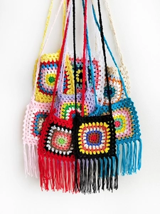 Detail of colorful handmade crochet granny square crossbody bags with fringe tassels