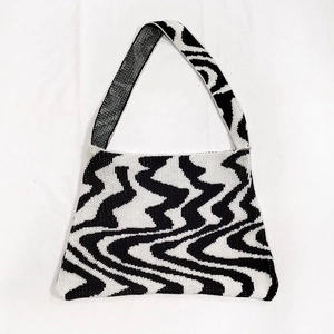 Close-up detail of thickened woven fabric and irregular black and white wave pattern