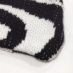 Close-up of the thick knitted wave texture and bicolor black and white woven pattern