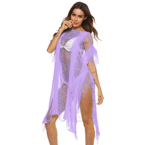 Detail of purple hollow knit beach cover-up featuring fringe tassels and woven texture