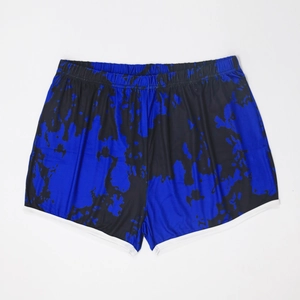Detail view of tie-dye print shorts featuring white contrast piping and side slits