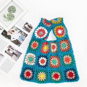Handmade granny square crochet tote bag in blue with colorful patchwork patterns