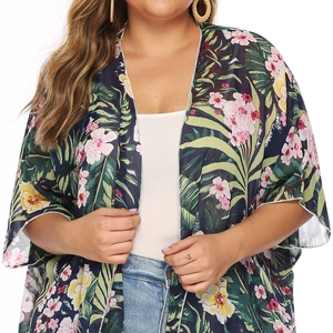 Detail of tropical floral chiffon cardigan featuring palm leaf prints and fringe tassels