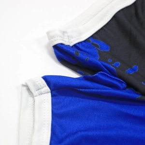 Detail shot of tie-dye printed beach shorts with white piping and breathable fabric texture