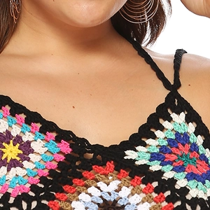 Detailed close-up of handmade crochet bikini top with colorful granny square patterns