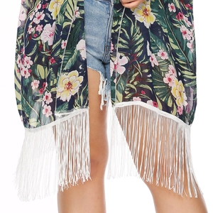 Close-up of tropical floral print chiffon kimono featuring long white decorative tassels