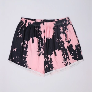 Detail of pink and black tie-dye lounge shorts with elastic waist and white piping