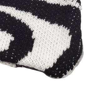 Black and white wavy pattern knit shoulder bag featuring irregular abstract zebra stripes