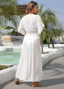Detail of white lace patchwork beach cover-up with hollow crochet waist and V-neck back