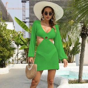 Détail de la mini-robe en crochet vert avec col en V profond, découpes et anneau décoratif