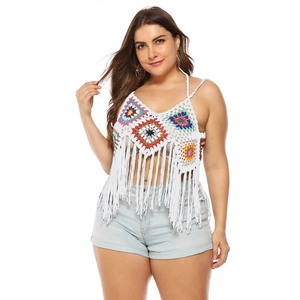 Detail of white crochet top with colorful geometric flowers and long fringe hem