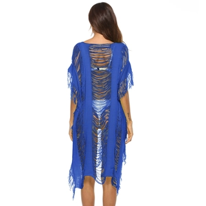 Detailed back view of bright royal blue knit beach cover-up with fringe and cut-out texture