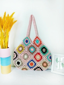 Detail of handmade crochet tote bag featuring vibrant colorful floral granny squares