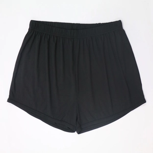 Detail of black ribbed knit lounge shorts showing elastic waistband and fabric texture