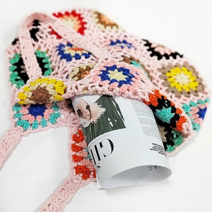Detail of handmade crochet tote bag with colorful granny square patterns and soft texture