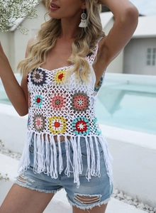 Detail of handmade crochet vest featuring colorful sunflower patterns and long fringe hem