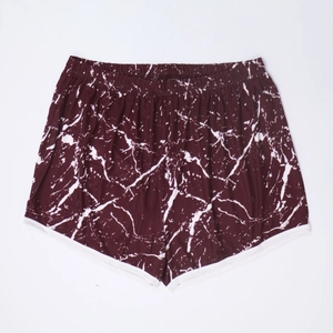 Close-up of wine red shorts with white marble print and elastic waist for women