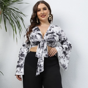 Détail d'un crop top tie-dye grande taille avec col en V profond et manches longues évasées
