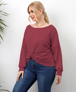 Detail of burgundy long sleeve top featuring twist knot hem and soft fabric texture