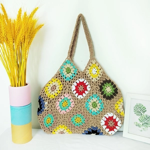 Detailed shot of handmade crochet tote bag with colorful bohemian flower patterns