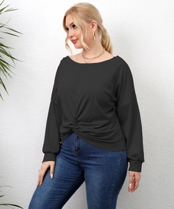 Detail showing the stylish twist knot hem on a plus-size black long sleeve top for women