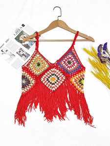 Detail of bohemian handmade crochet halter top with colorful granny squares and red fringe