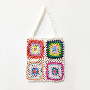 Close-up of handmade crochet granny square tote bag with colorful patchwork patterns