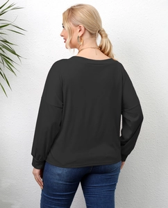 Detail view of the long sleeve black top with drop shoulder design and ribbed cuffs