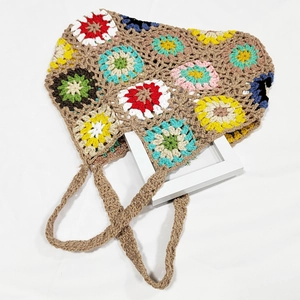 Detail of handmade crochet handbag with colorful bohemian sunflower pattern texture