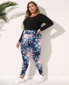 Women's two-piece casual set featuring a black long sleeve top and floral leggings