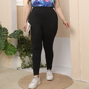 Close-up of black high-waist slimming leggings with high elastic knitted fabric detail
