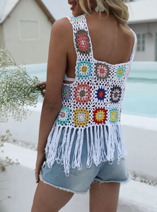 Detailed back view of crochet boho top featuring colorful flower patches and long tassels