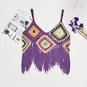 Macro detail of handmade crochet camisole featuring colorful granny squares and purple fringes