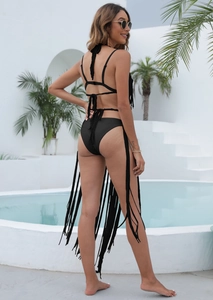Close-up of black bikini with ultra-long fringe tassels for a bohemian beach holiday look