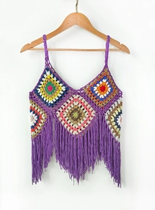Detail of bohemian colorful crochet halter top with purple fringe on wooden hanger